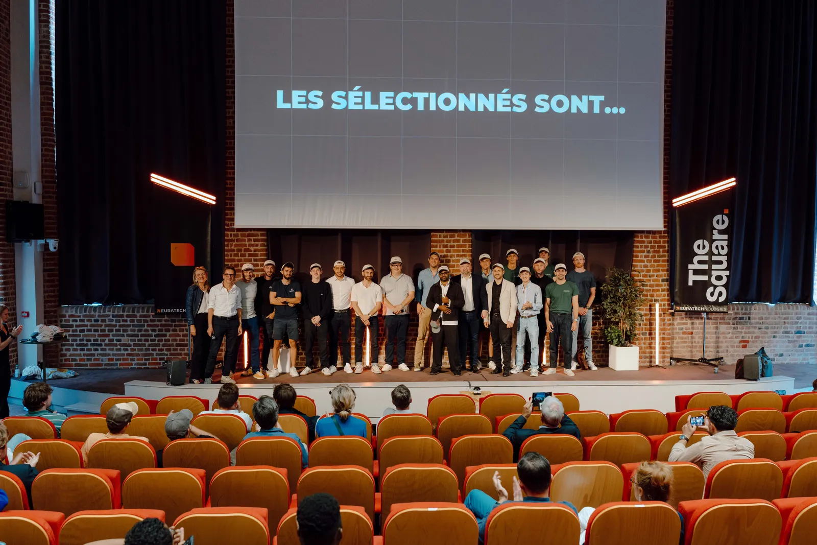 The eleven laureates of EuraTechnologies' The Square accelerator on stage at the final jury, under the slide reading Les sélectionnés sont...